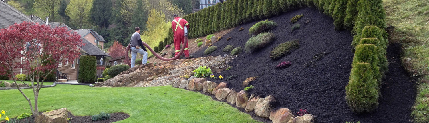 black mulch installation with blower truck