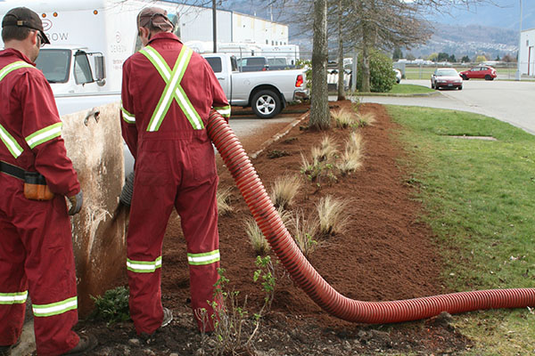 Blower Truck Services laying landscape mulch