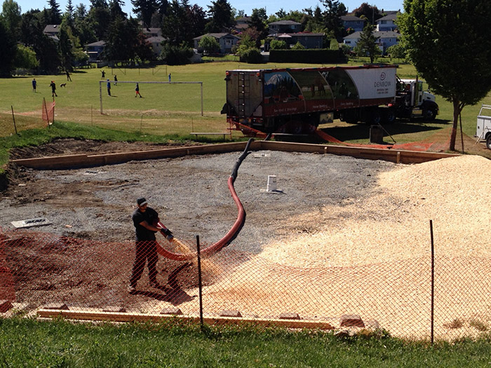 Denbow blower truck installing playground wood chips in Victoria